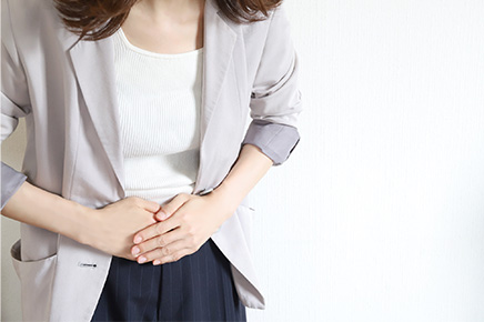 便秘によるお腹の不調に悩む女性