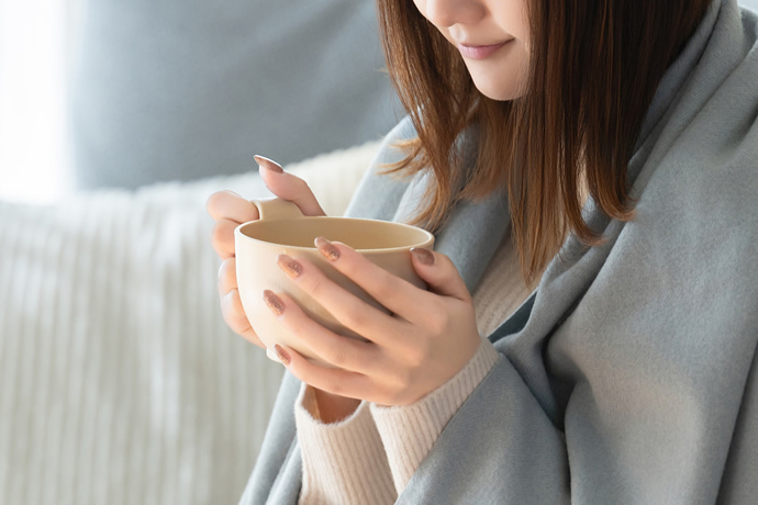 風邪をひいて水を飲んでいる女性